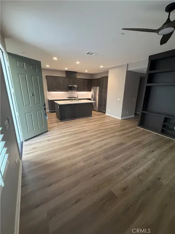 a view of kitchen with sink and refrigerator