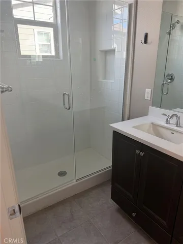 a bathroom with a sink a shower and a mirror