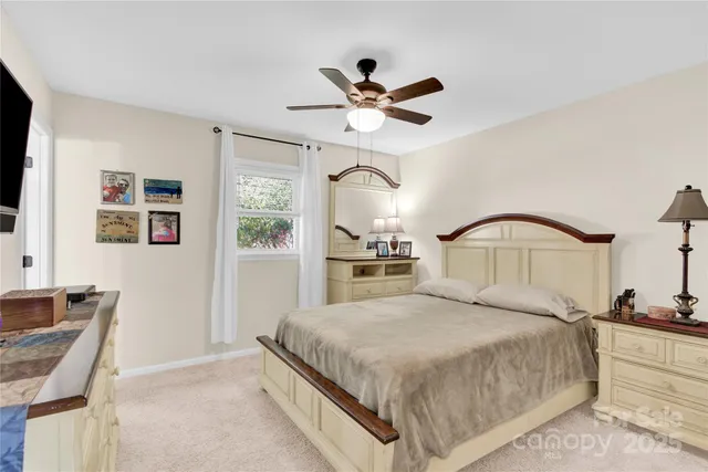 a bedroom with a large bed and a chandelier