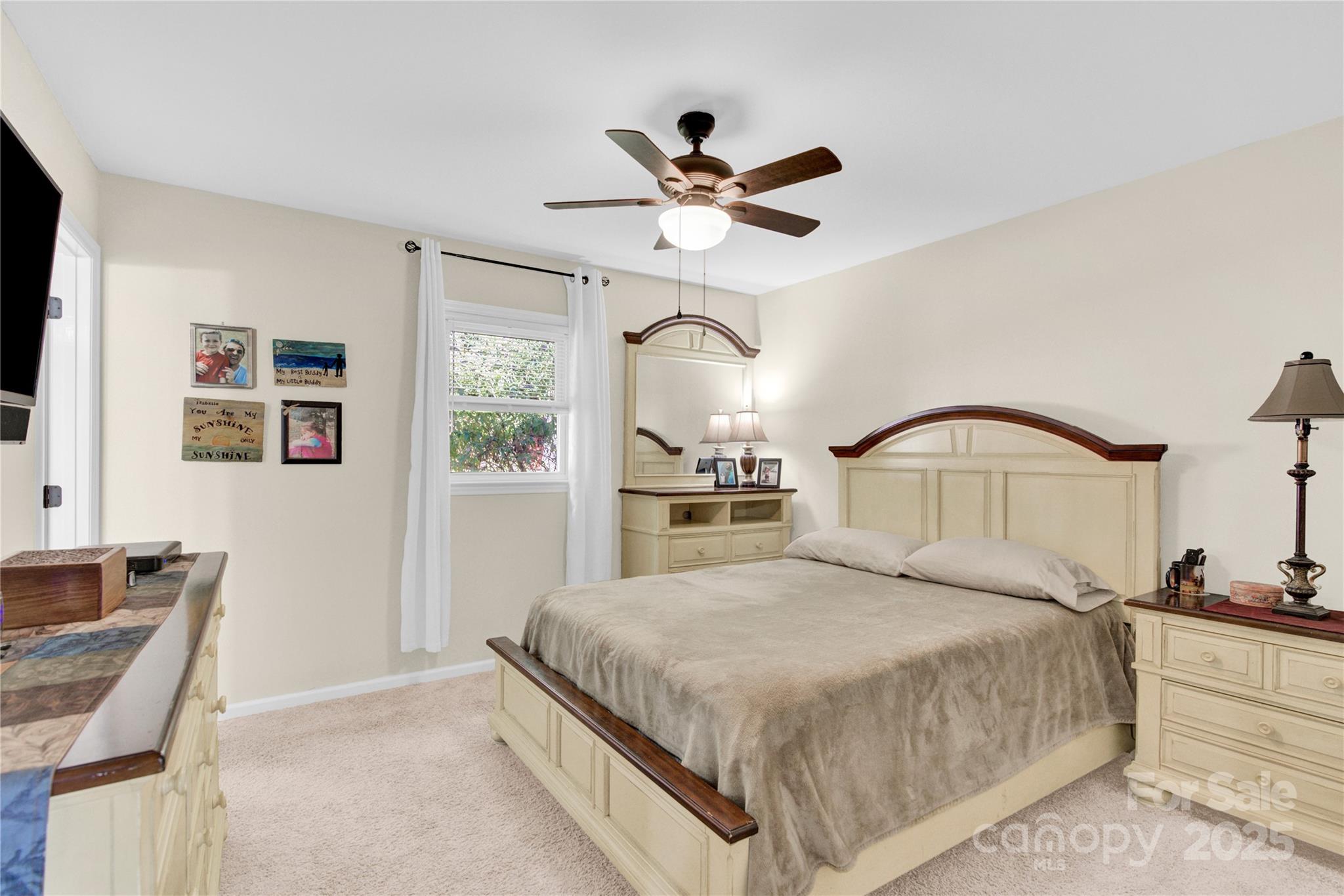 159 Bowman Road Statesville, NC 28625 - Photo 15 of 38 a bedroom with a large bed and a chandelier