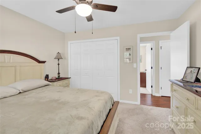 a bedroom with a bed chandelier and a window