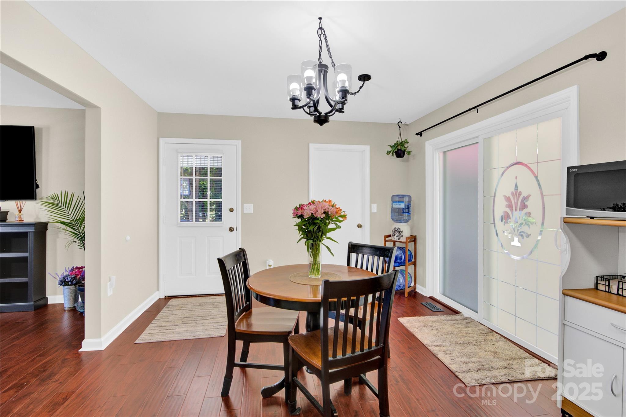 159 Bowman Road Statesville, NC 28625 - Photo 18 of 38 a view of a dining room with furniture wooden floor and a chandelier