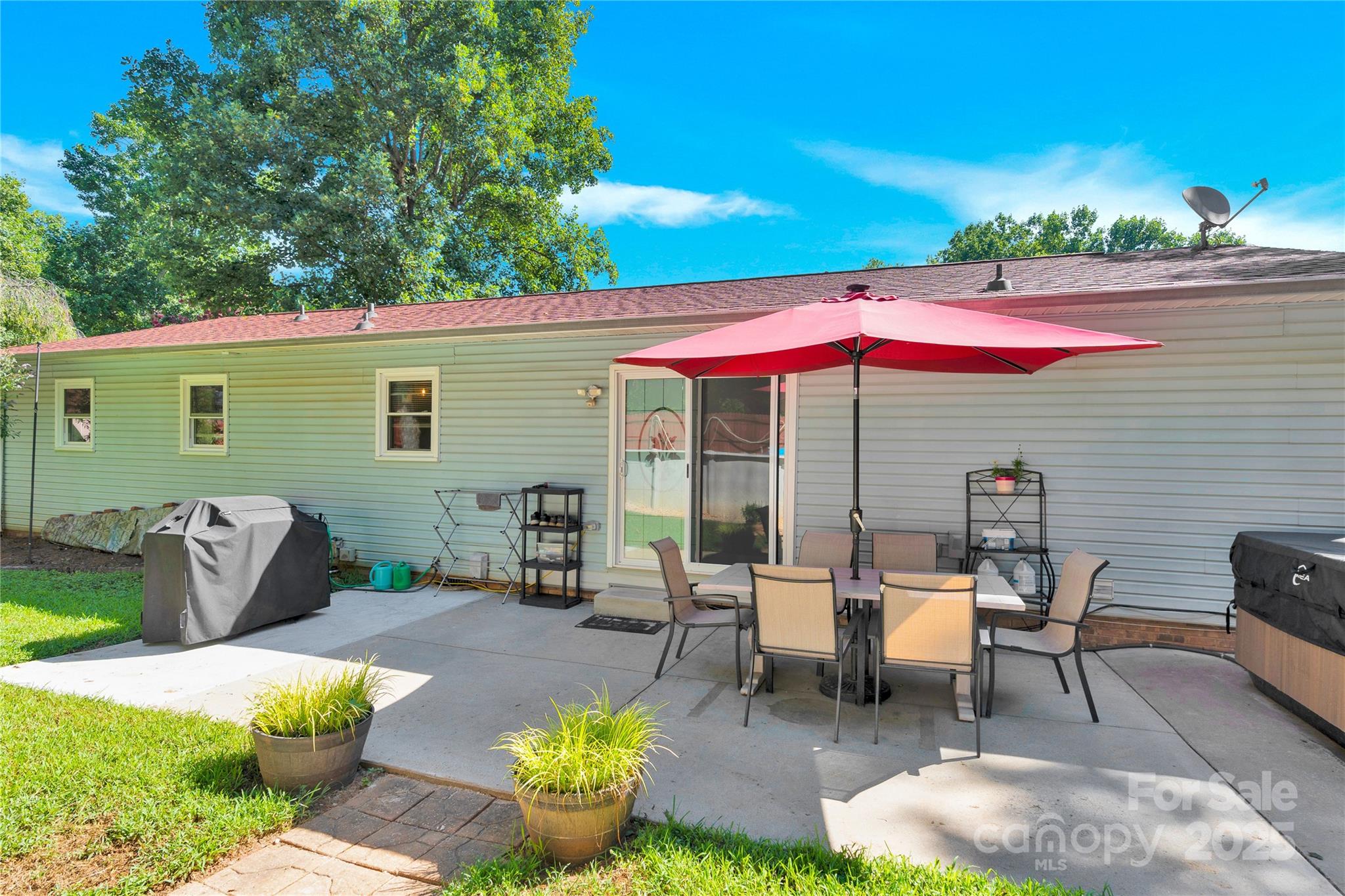159 Bowman Road Statesville, NC 28625 - Photo 29 of 38 a view of a patio with couches table and chairs under an umbrella