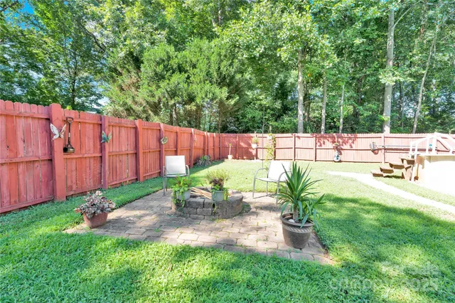 a view of a backyard with sitting area