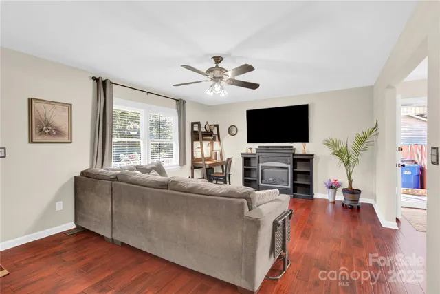a living room with fireplace furniture and a flat screen tv