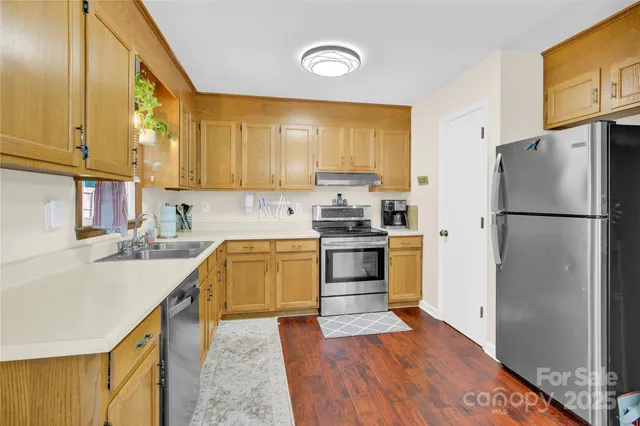 a kitchen with a sink a refrigerator and a stove