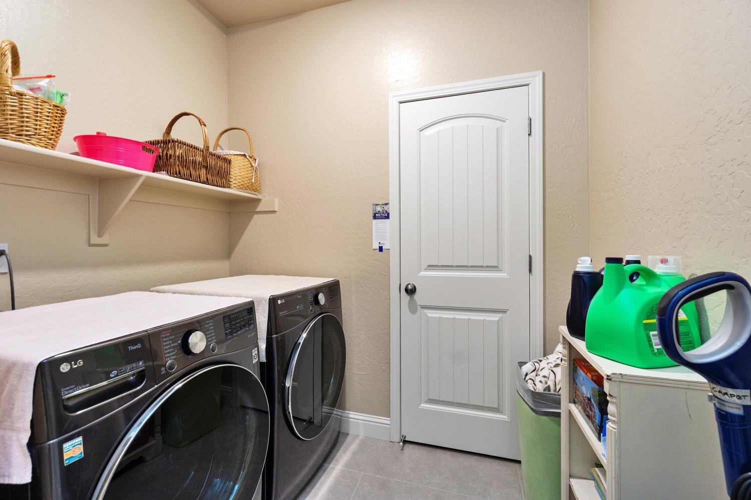 881 Strada Street Lemoore, CA 93245 - Photo 19 of 39 Laundry with storage/linen closet