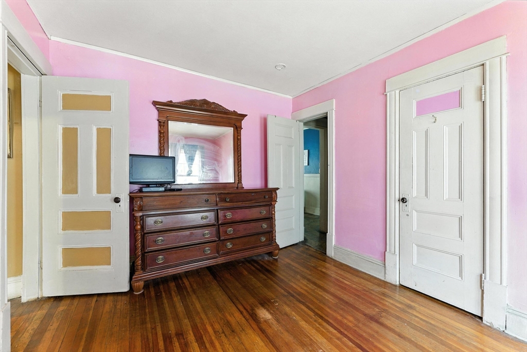 18-20 Eldridge Street Springfield, MA 01108 - Photo 13 of 42 a room with a bed and a mirror