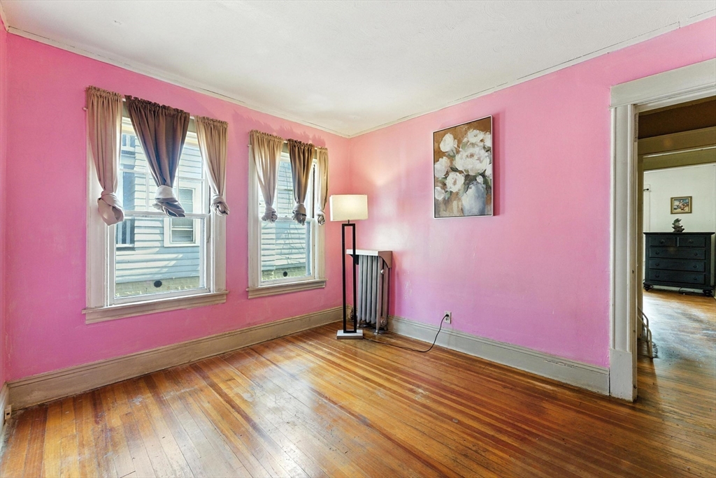 18-20 Eldridge Street Springfield, MA 01108 - Photo 14 of 42 a view of empty room with wooden floor and fan
