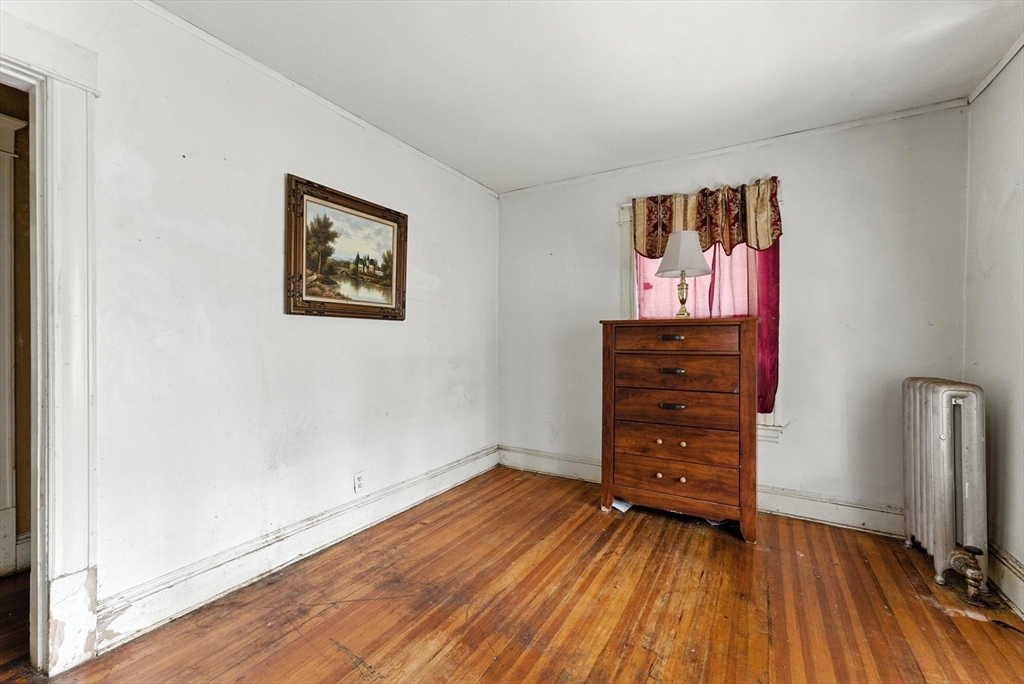 18-20 Eldridge Street Springfield, MA 01108 - Photo 16 of 42 an empty room with wooden floor and closet