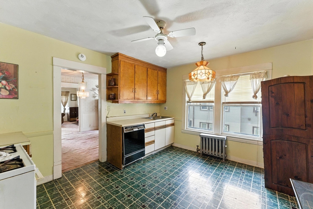 18-20 Eldridge Street Springfield, MA 01108 - Photo 18 of 42 a kitchen with granite countertop a stove and a refrigerator
