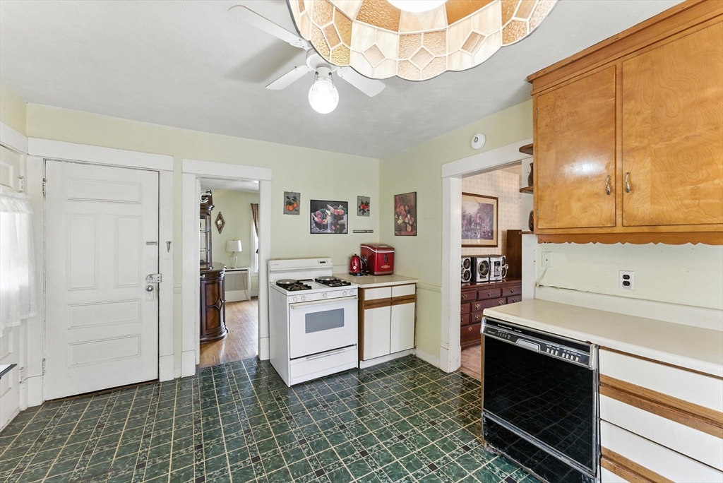 18-20 Eldridge Street Springfield, MA 01108 - Photo 20 of 42 a kitchen with white cabinets and stainless steel appliances