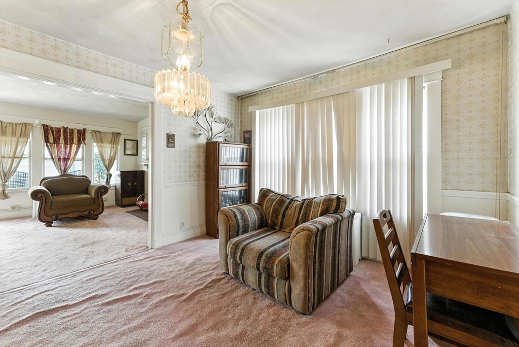 18-20 Eldridge Street Springfield, MA 01108 - Photo 23 of 42 a living room with furniture and a chandelier