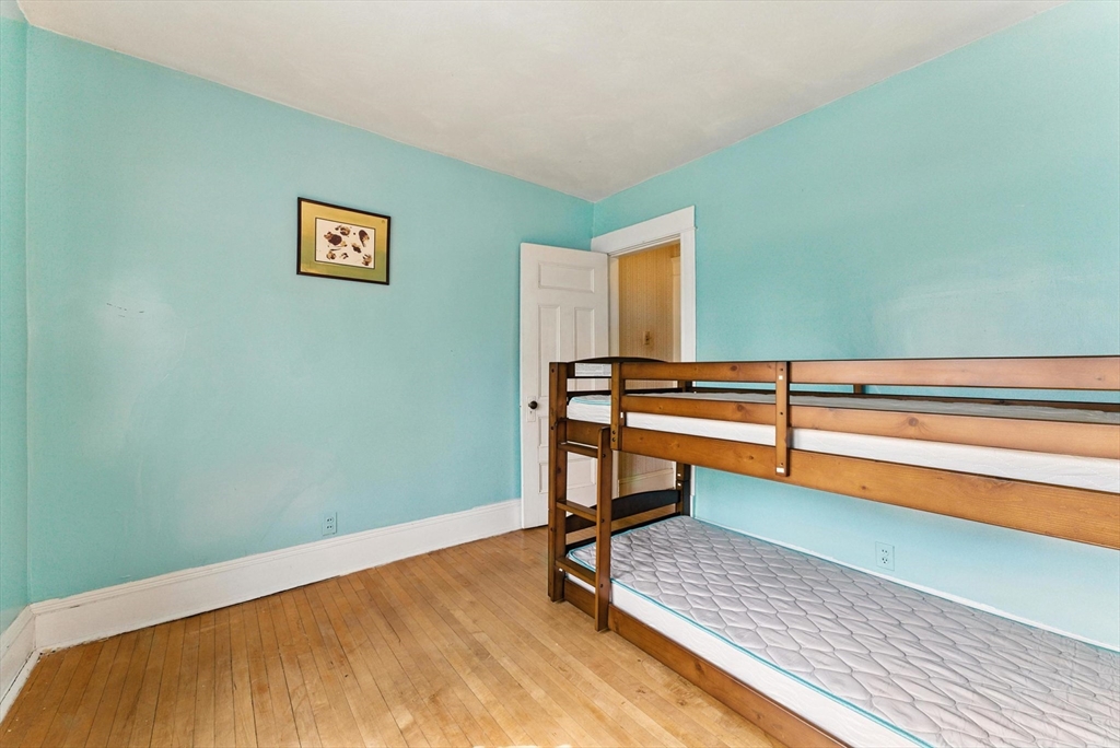 18-20 Eldridge Street Springfield, MA 01108 - Photo 29 of 42 a view of a room with wooden floor and chair