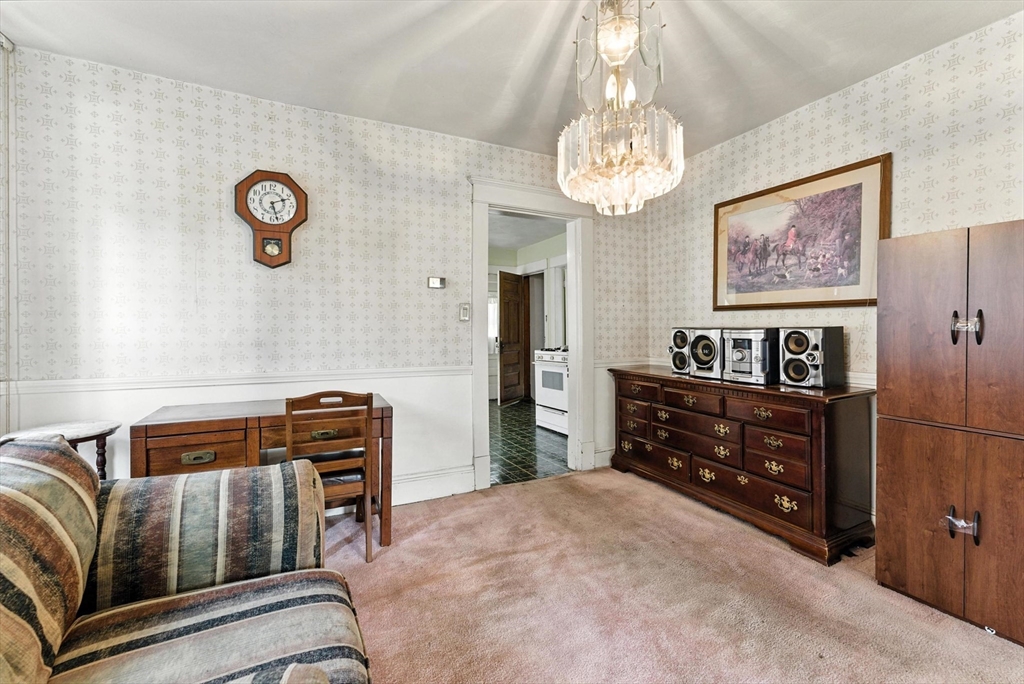 18-20 Eldridge Street Springfield, MA 01108 - Photo 31 of 42 a bedroom with furniture and a chandelier