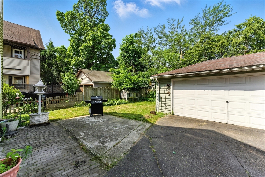 18-20 Eldridge Street Springfield, MA 01108 - Photo 38 of 42 a view of a house with a yard and garage