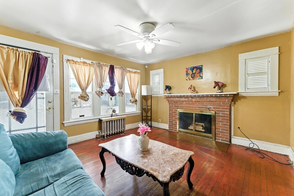 18-20 Eldridge Street Springfield, MA 01108 - Photo 8 of 42 a living room with furniture and a fireplace