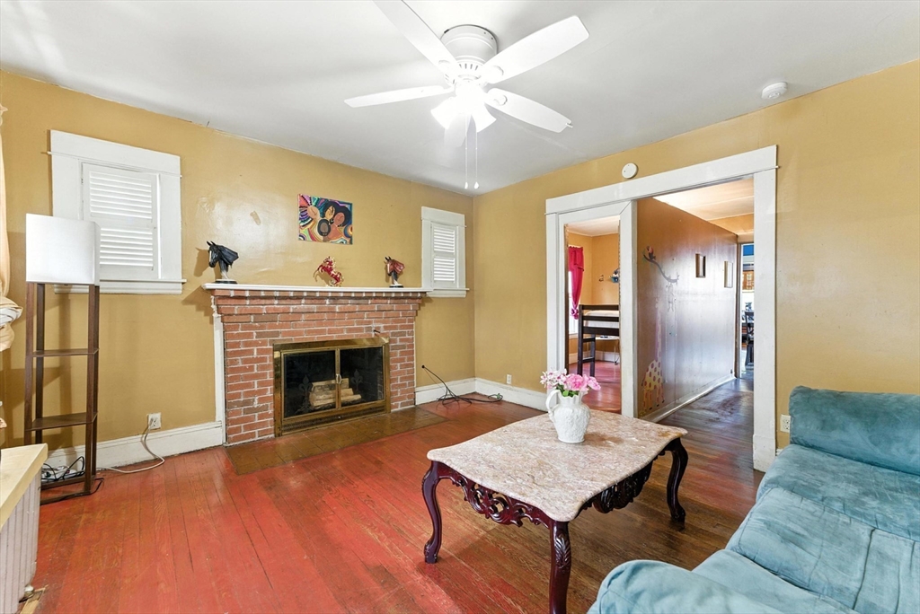 18-20 Eldridge Street Springfield, MA 01108 - Photo 10 of 42 a living room with furniture and a fireplace