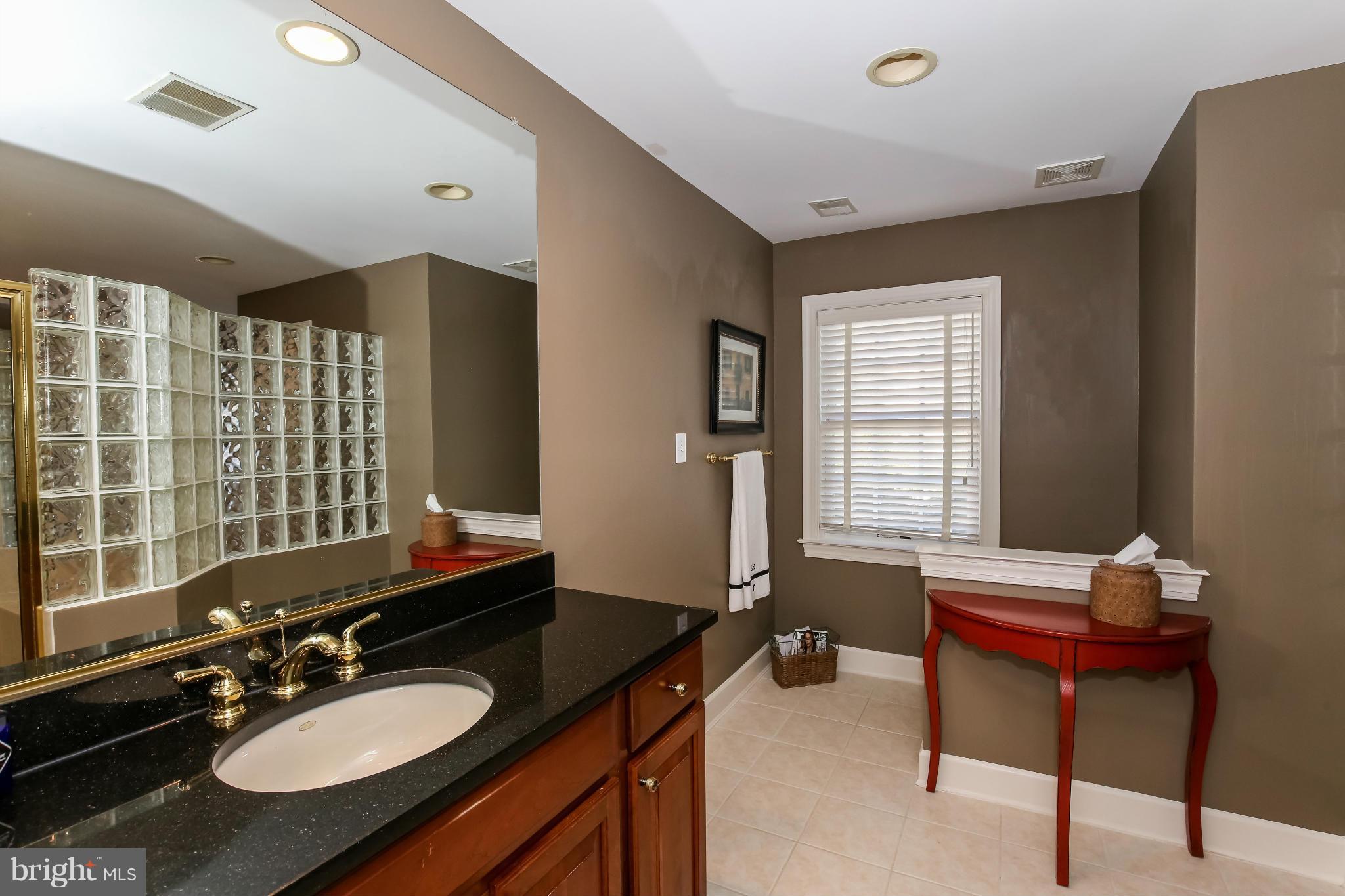 10403 Grey Fox Road Potomac, MD 20854 - Photo 13 of 23 a bathroom with a sink double vanity granite and a mirror