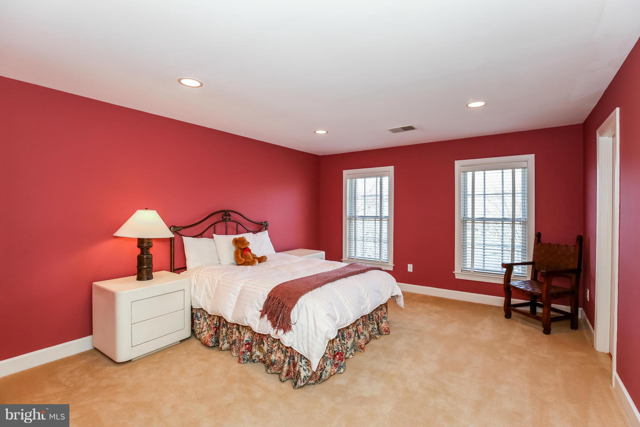 10403 Grey Fox Road Potomac, MD 20854 - Photo 16 of 23 a spacious bedroom with a bed and a chandelier