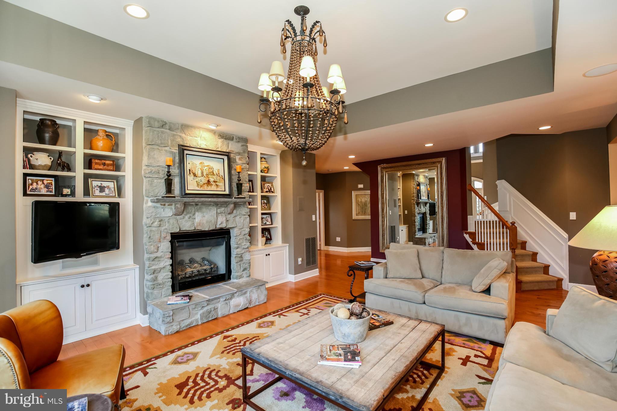 10403 Grey Fox Road Potomac, MD 20854 - Photo 5 of 23 a living room with furniture a flat screen tv and a fireplace