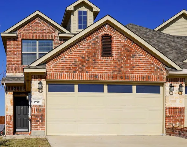 a front view of a house with garage