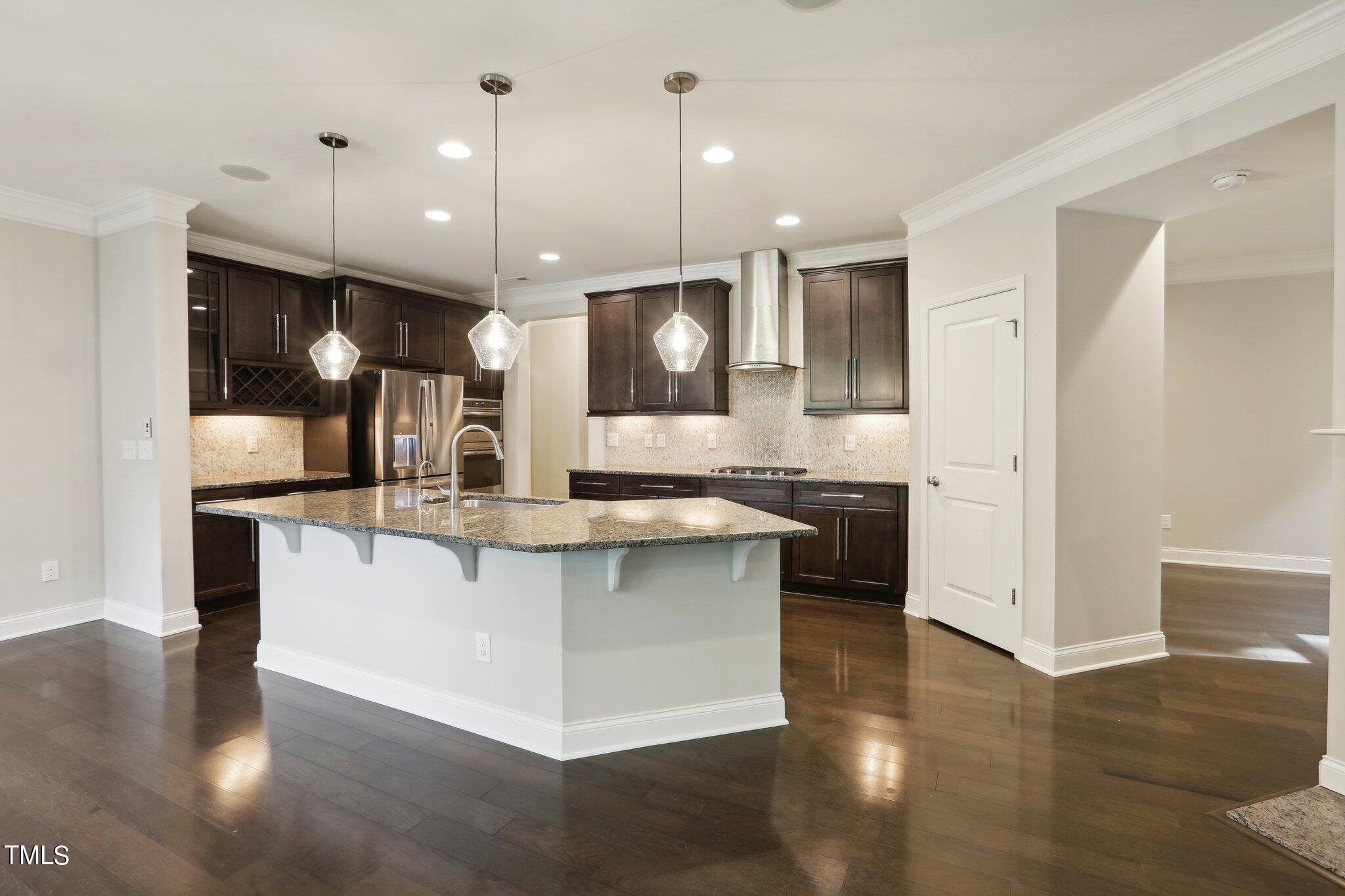 517 Plainview Avenue Raleigh, NC 27604 - Photo 13 of 58 a large kitchen with stainless steel appliances kitchen island a large island in the center