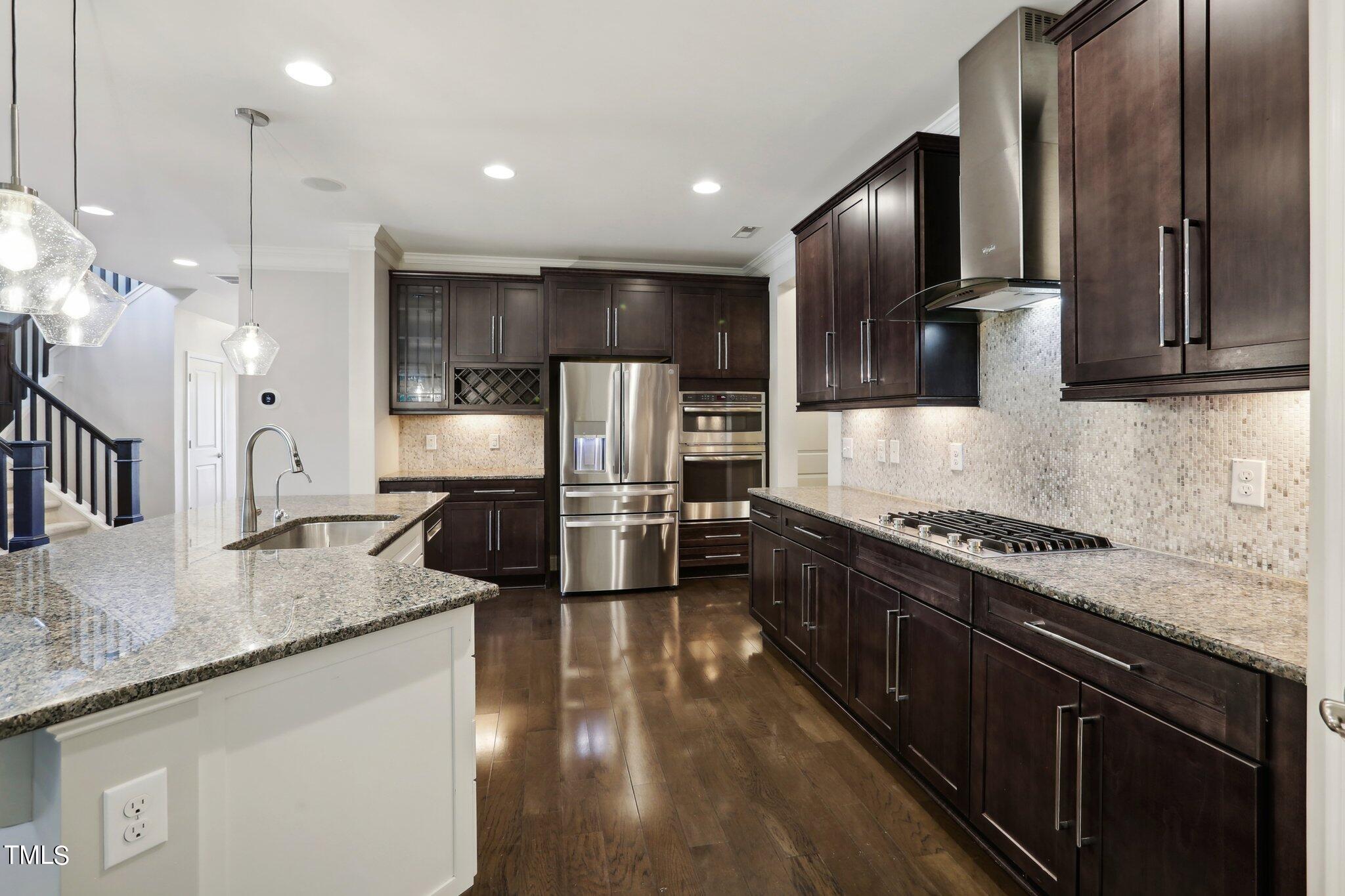 517 Plainview Avenue Raleigh, NC 27604 - Photo 14 of 58 a large kitchen with granite countertop a large counter top a sink stainless steel appliances and cabinets