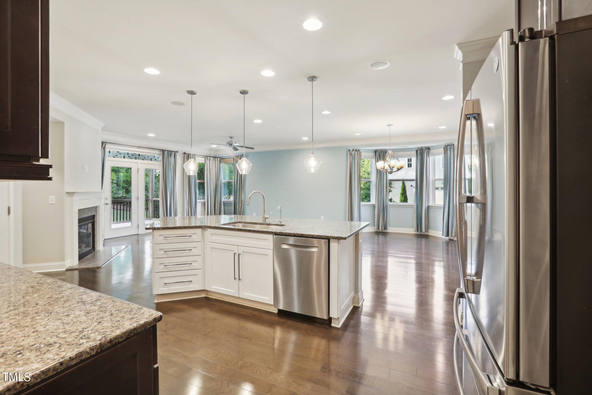 517 Plainview Avenue Raleigh, NC 27604 - Photo 16 of 58 a kitchen with stainless steel appliances granite countertop a refrigerator a sink and a stove