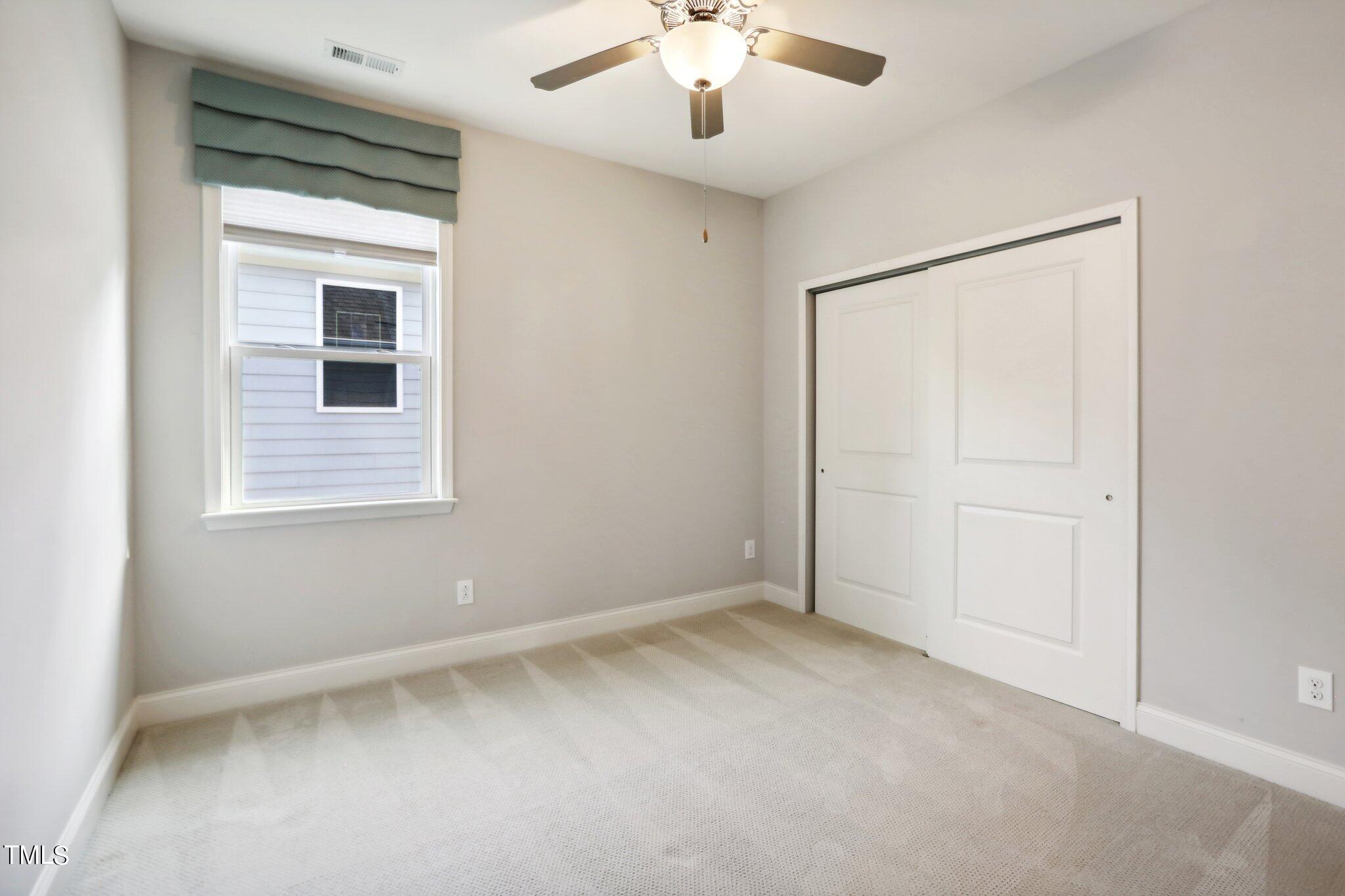 517 Plainview Avenue Raleigh, NC 27604 - Photo 32 of 58 an empty room with a window and a ceiling fan