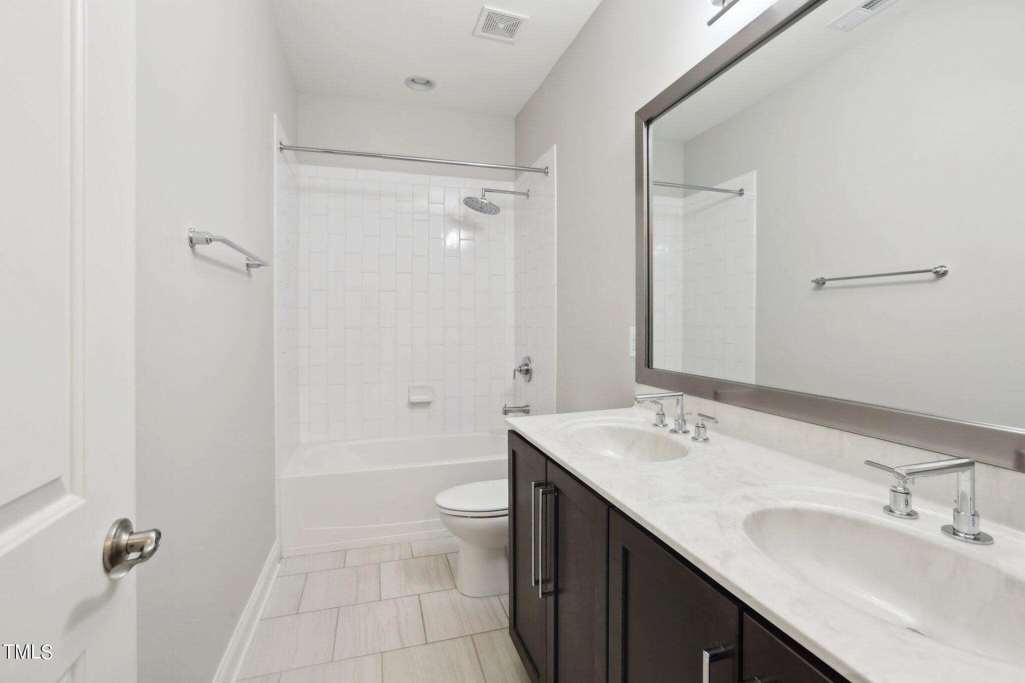 517 Plainview Avenue Raleigh, NC 27604 - Photo 34 of 58 a bathroom with a double vanity sink toilet mirror and shower