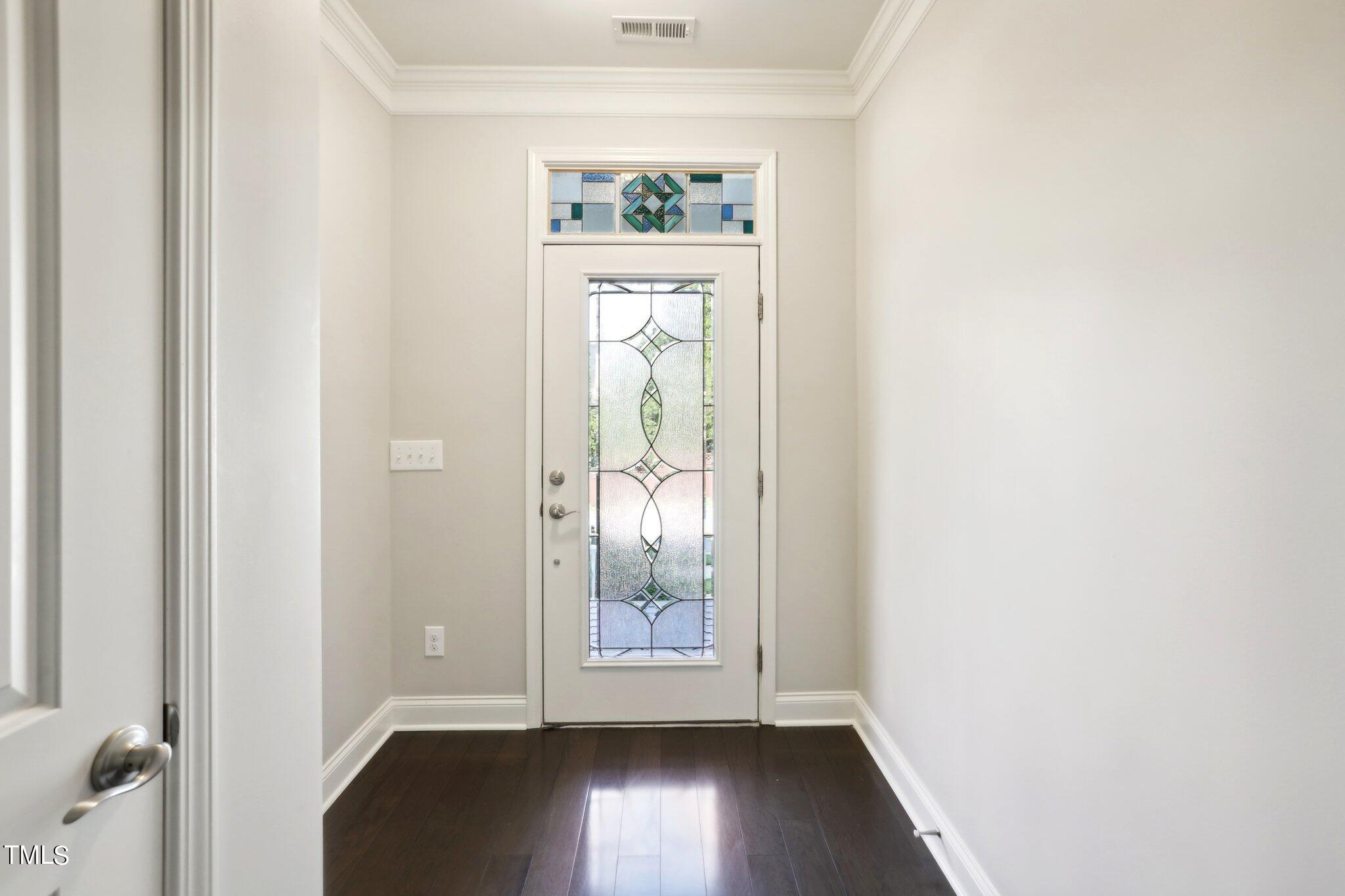 517 Plainview Avenue Raleigh, NC 27604 - Photo 4 of 58 an empty room with wooden floor mirror and windows