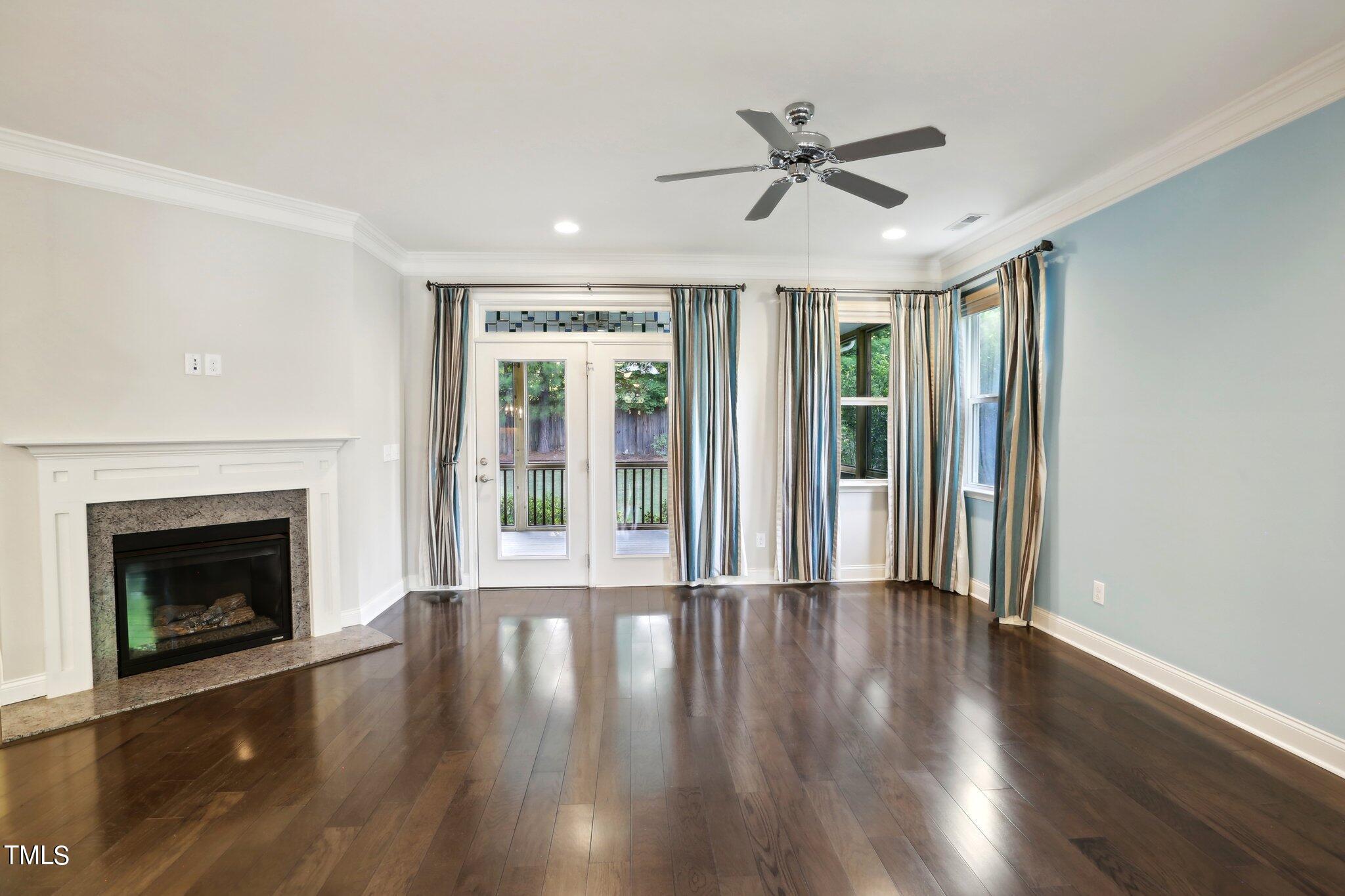 517 Plainview Avenue Raleigh, NC 27604 - Photo 8 of 58 a view of an empty room with wooden floor fireplace and a window