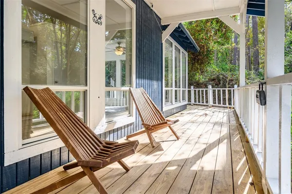 a view of balcony with a large window and wooden floor