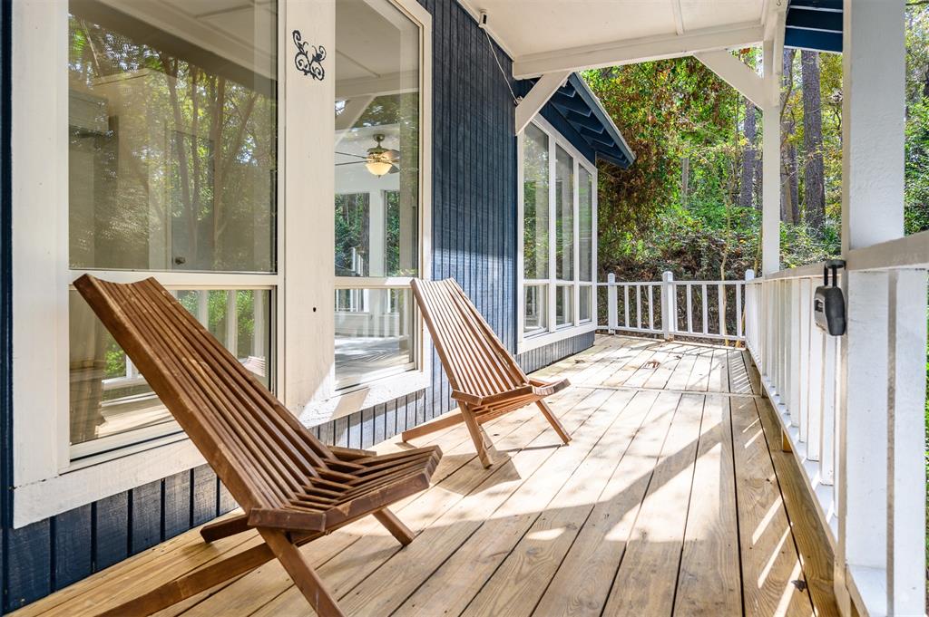 a view of balcony with a large window and wooden floor