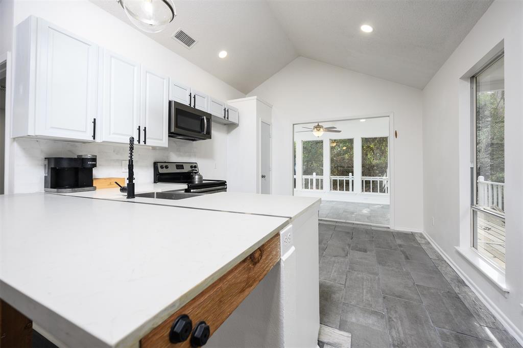 188 Candlelight Path Hawkins, TX 75765 - Photo 17 of 25 a kitchen with stainless steel appliances a stove top oven a sink a microwave and a refrigerator
