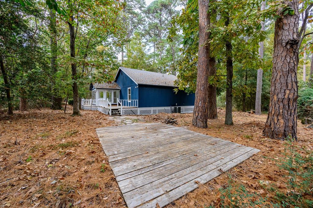 188 Candlelight Path Hawkins, TX 75765 - Photo 19 of 25 a backyard of a house with table and chairs a fire pit and large trees