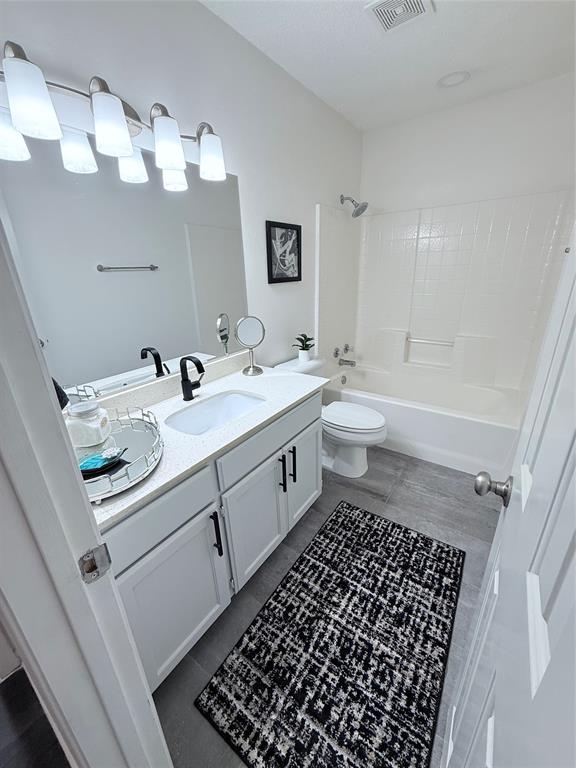 188 Candlelight Path Hawkins, TX 75765 - Photo 5 of 25 a bathroom with a sink a toilet and a mirror