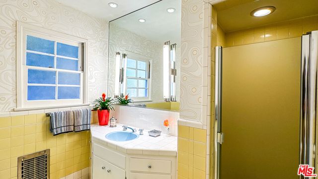 a bathroom with a sink mirror and a bathtub