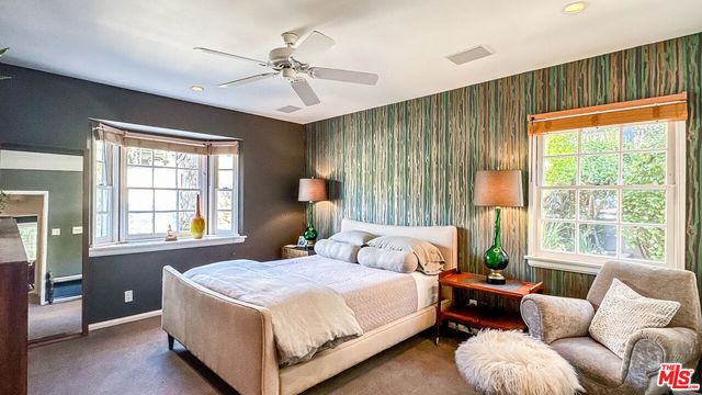 a bedroom with a bed and a couch