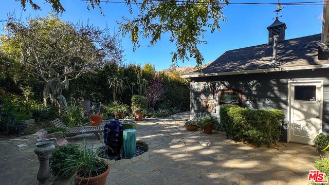 a view of a house with potted plants