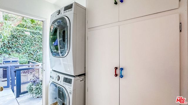 a view of a storage & utility room with a washer dryer
