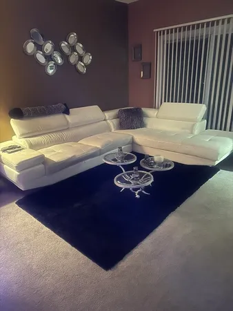 a room with a table chairs and chandelier