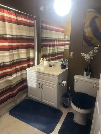 a bathroom with a sink toilet and shower