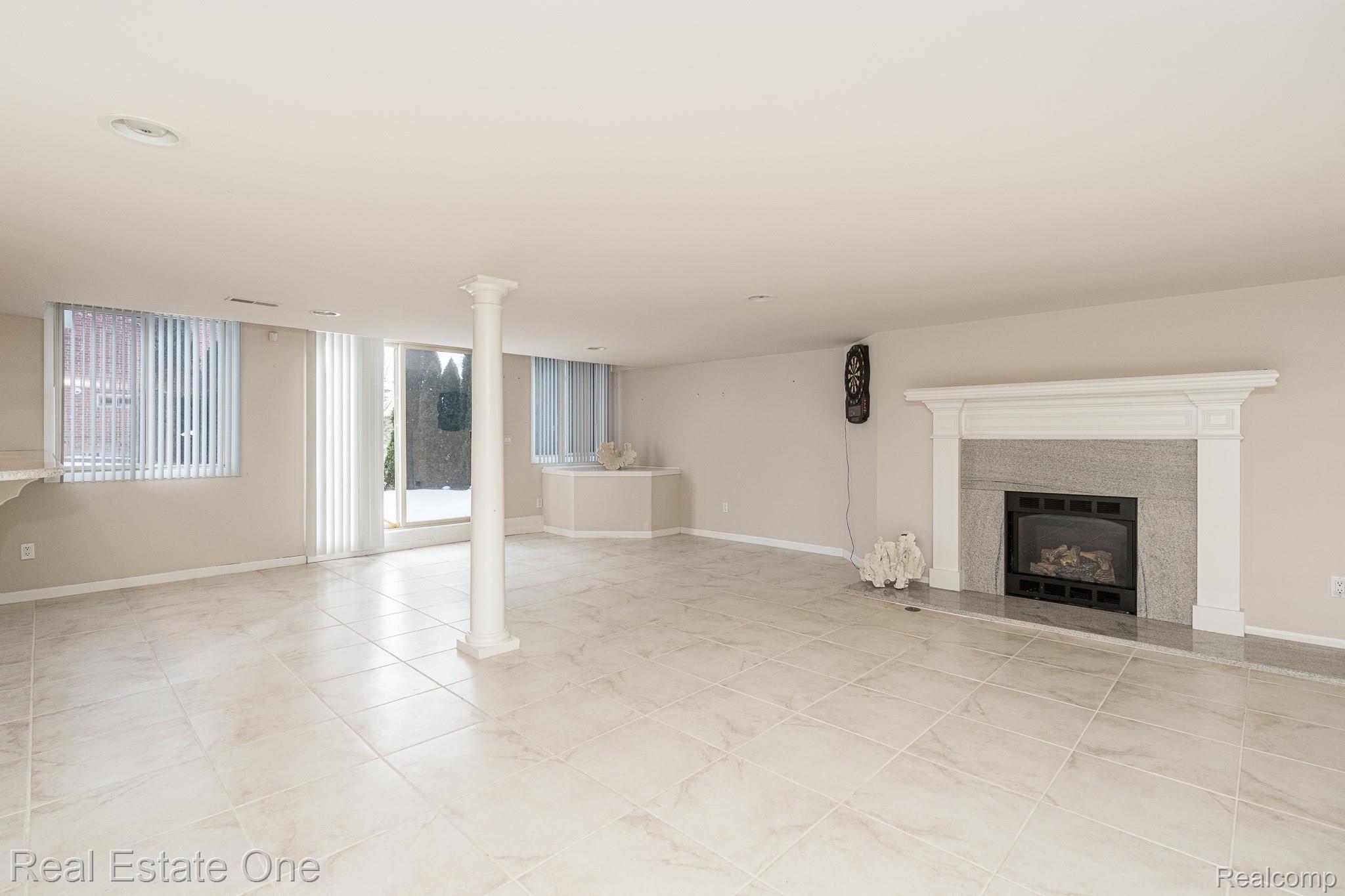 115 Scarborough Lane Rochester, MI 48306 - Photo 37 of 46 Finished walk out basement with gas fireplace