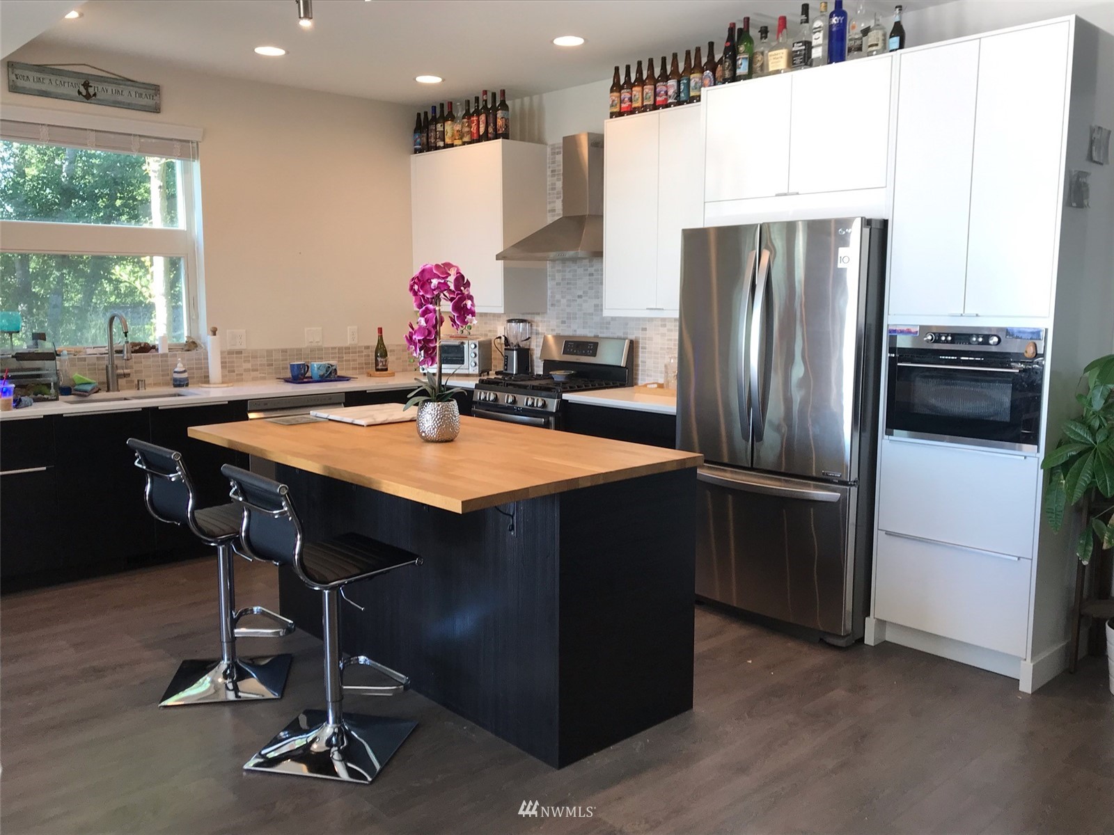 920 Ruby Street Blaine, WA 98230 - Photo 8 of 40 a kitchen with stainless steel appliances a sink a refrigerator and wooden cabinets