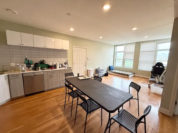 a view of kitchen with cabinets table and chairs