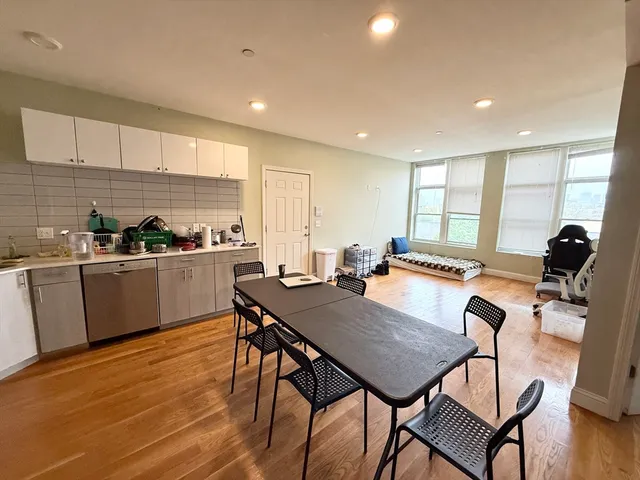 a view of kitchen with cabinets table and chairs