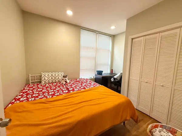 a bedroom with a bed and a window