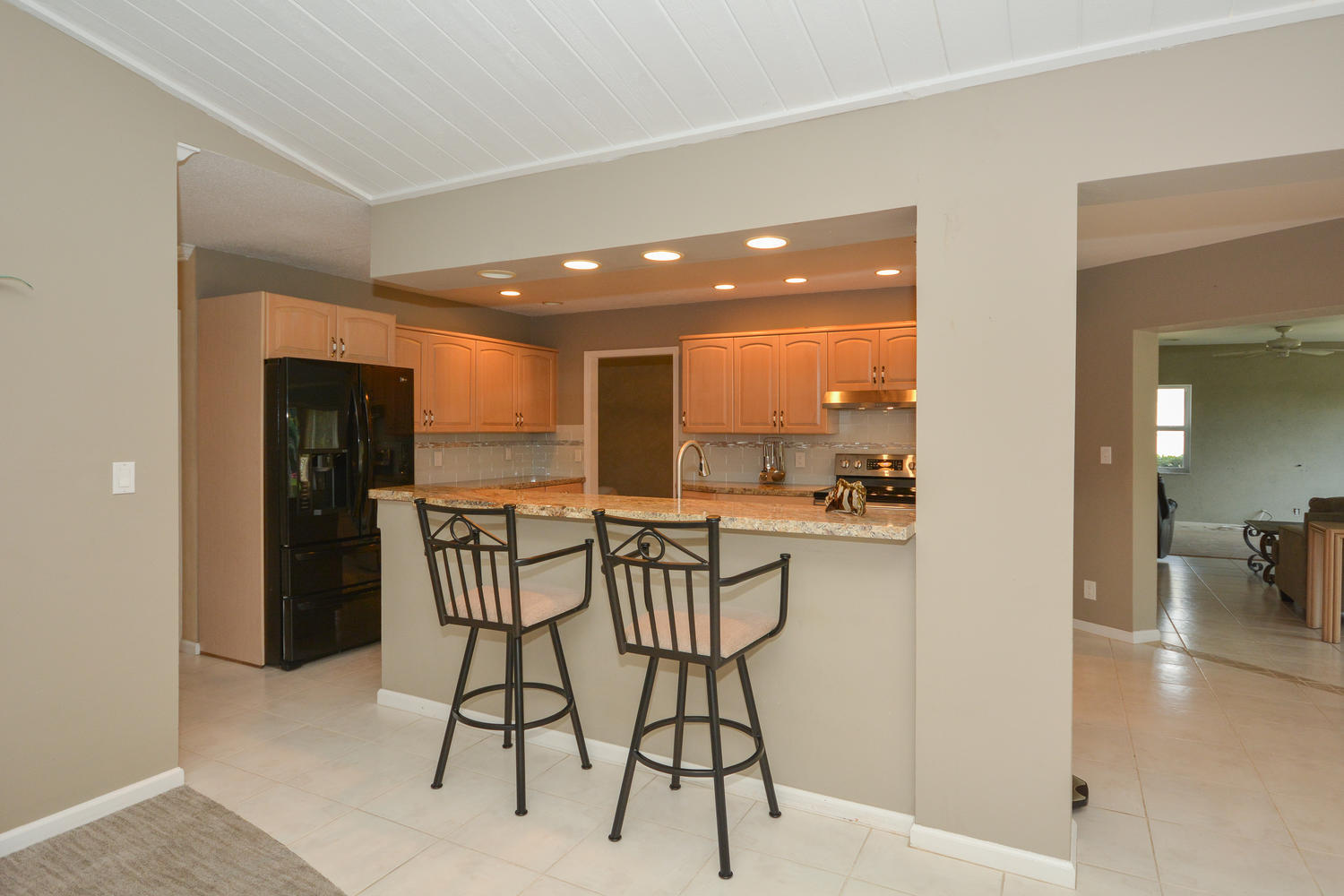 200 North Country Club Boulevard Boca Raton, FL 33487 - Photo 8 of 27 a view of a kitchen and a dining table & chairs in a room